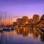 Sarasota bayfront marina with sailboats and condo towers at dusk